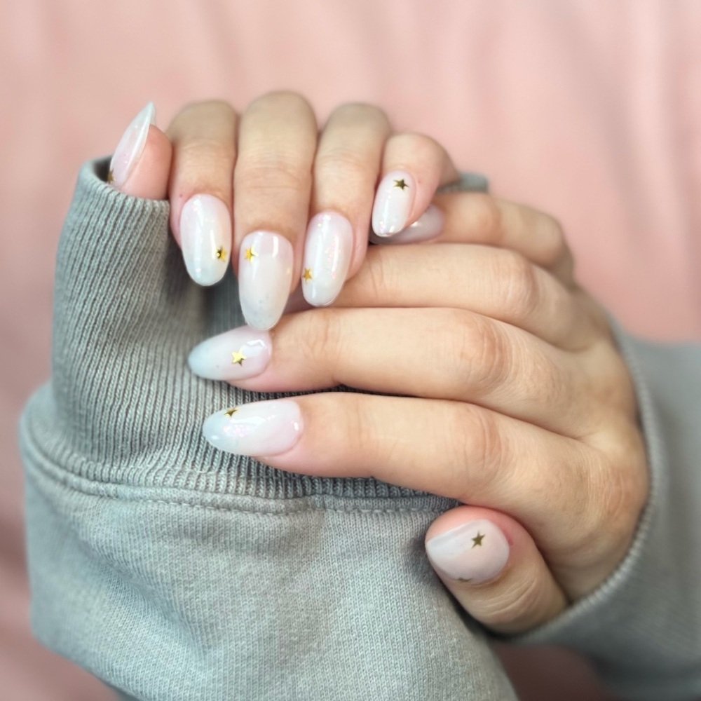 Milky white iridescent flakes and stars press on gel nails • short round shape